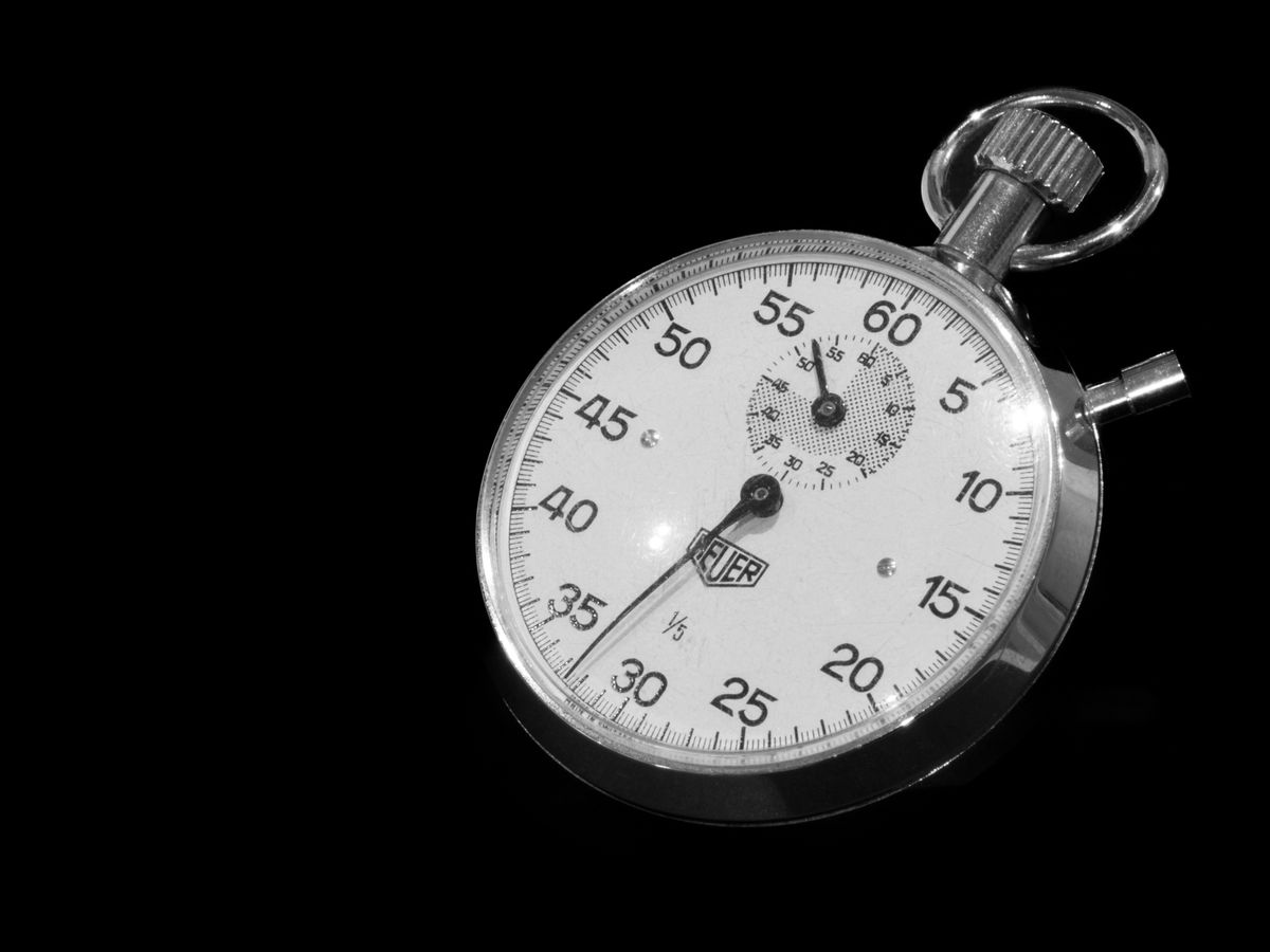 A vintage mechanical stopwatch with a black dial